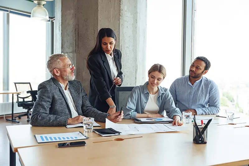 Equipo de profesionales en una reunión de negocios discutiendo estrategias financieras - Asesoría empresarial en LaoN